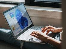 person using Windows 11 computer on lap
