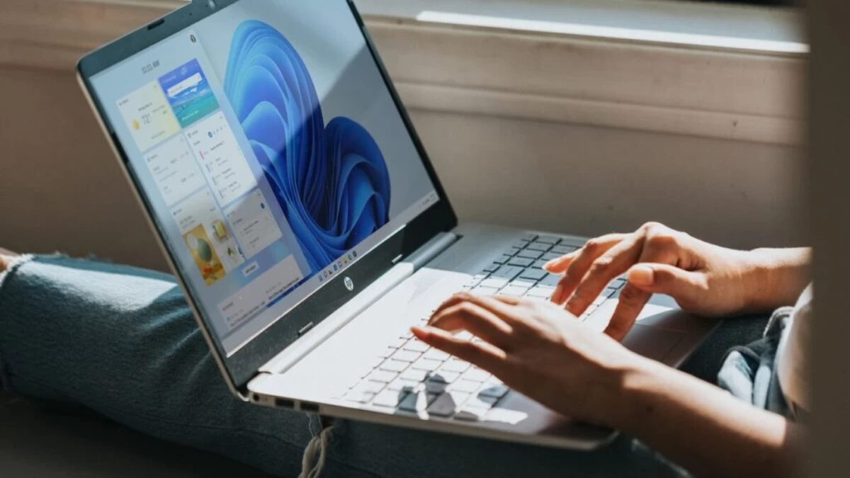 person using Windows 11 computer on lap
