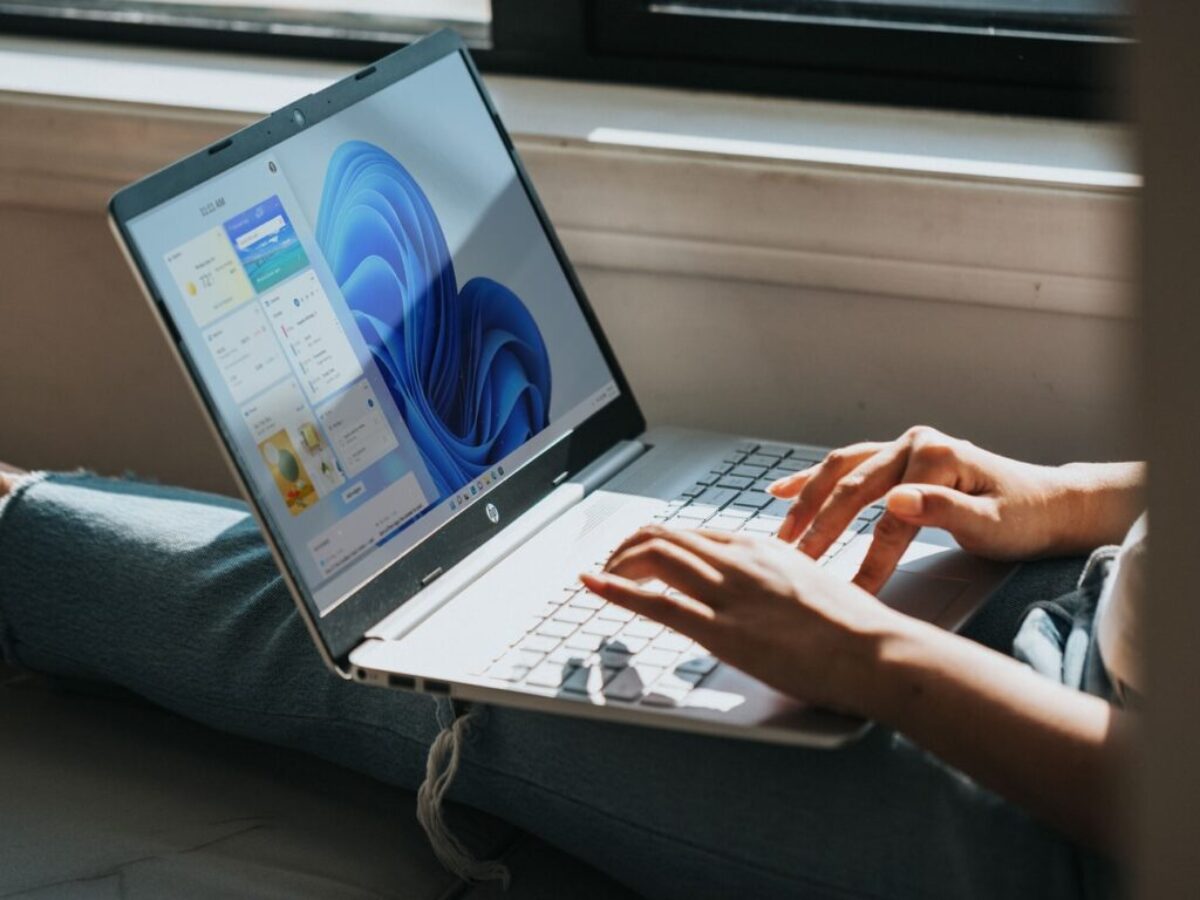 person using Windows 11 computer on lap