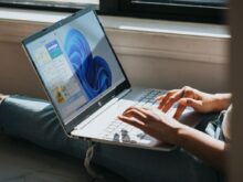 person using Windows 11 computer on lap