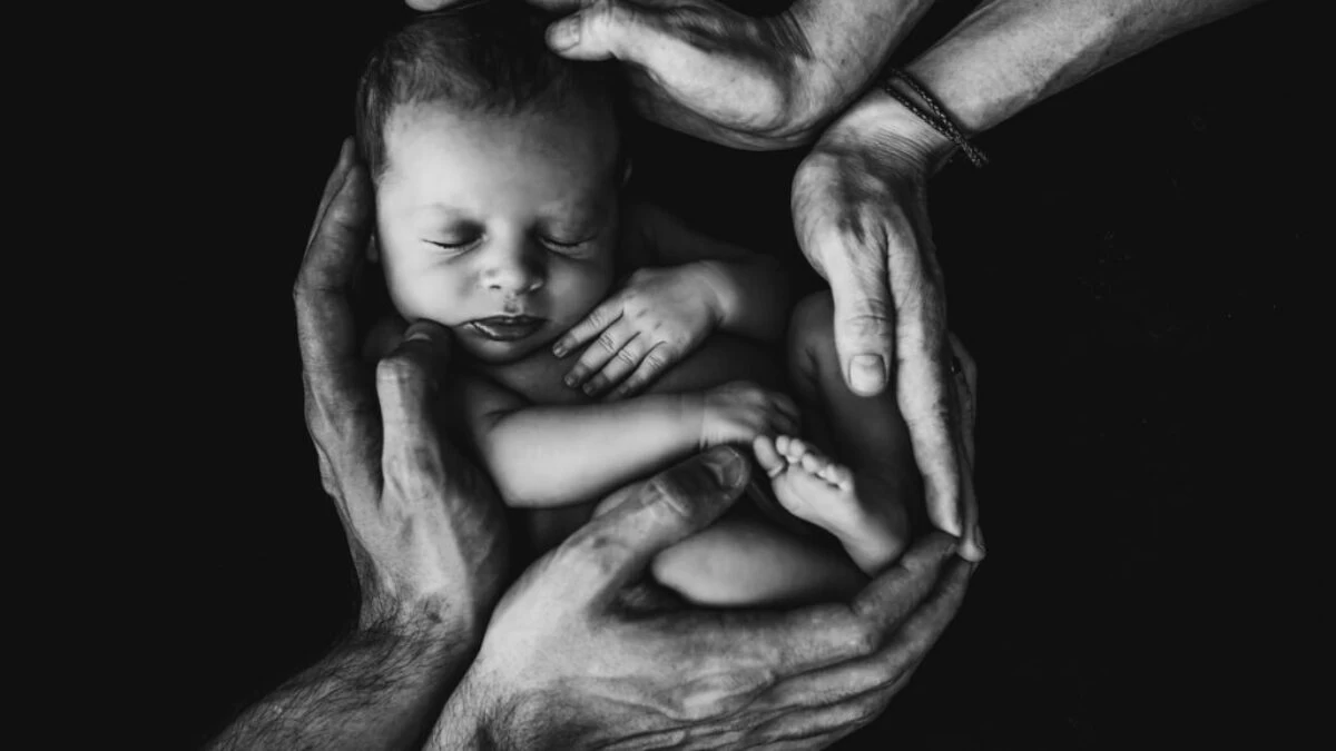 grayscale photo of woman hugging baby