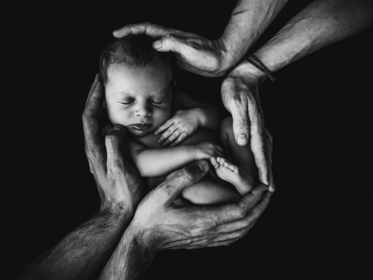 grayscale photo of woman hugging baby