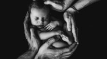 grayscale photo of woman hugging baby