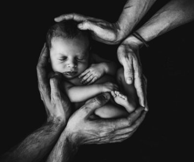 grayscale photo of woman hugging baby
