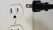 black male plug in front of electric socket