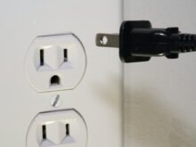 black male plug in front of electric socket