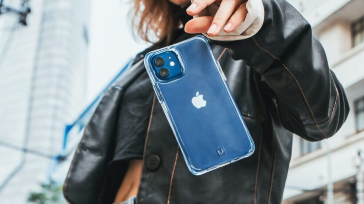 woman in black leather jacket holding blue iphone case