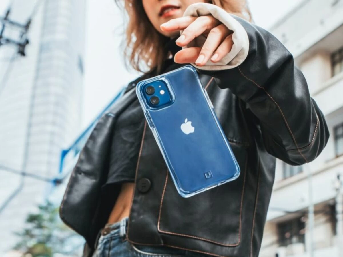 woman in black leather jacket holding blue iphone case