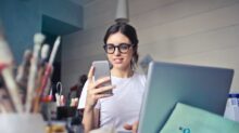 woman in white shirt using smartphone