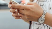 woman holding iPhone during daytime