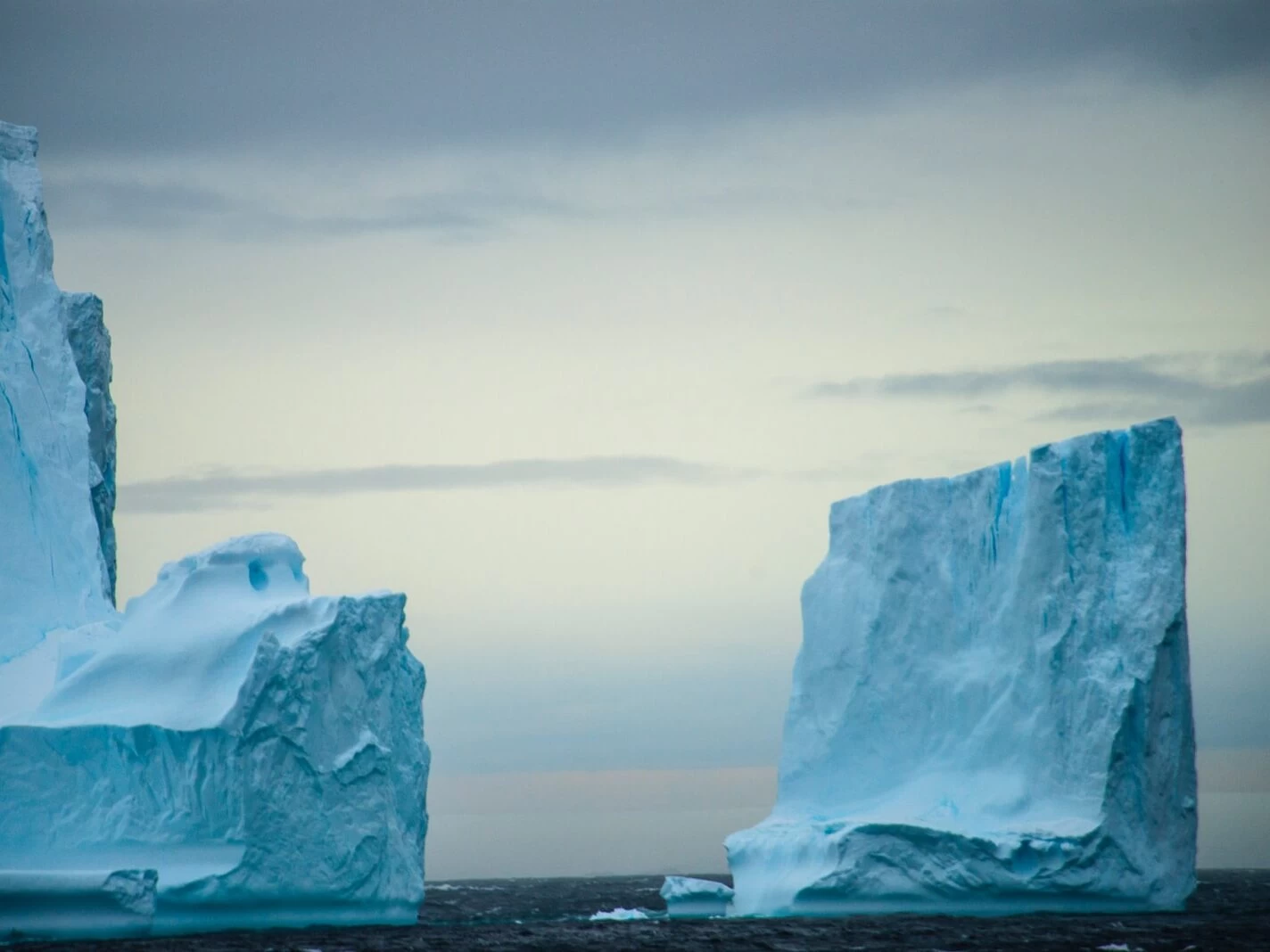 white rock formation on sea during daytime