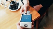 person holding credit card swipe machine