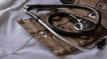 black stethoscope with brown leather case
