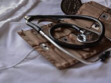 black stethoscope with brown leather case