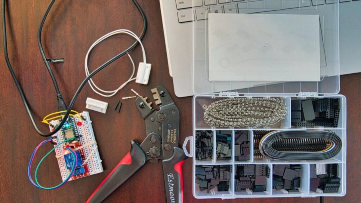 red and silver scissors beside white laptop computer