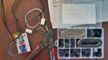red and silver scissors beside white laptop computer