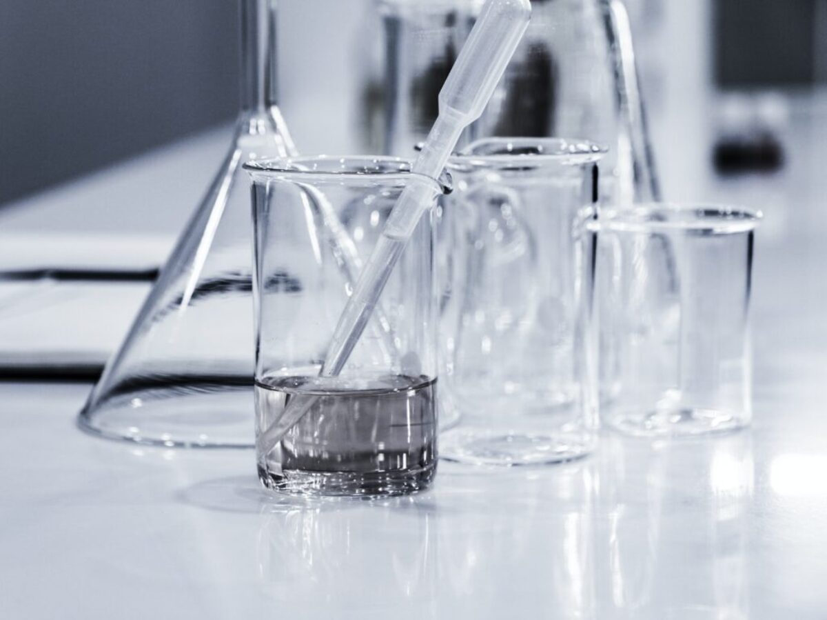 three clear beakers placed on tabletop