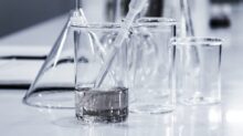 three clear beakers placed on tabletop