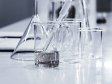 three clear beakers placed on tabletop