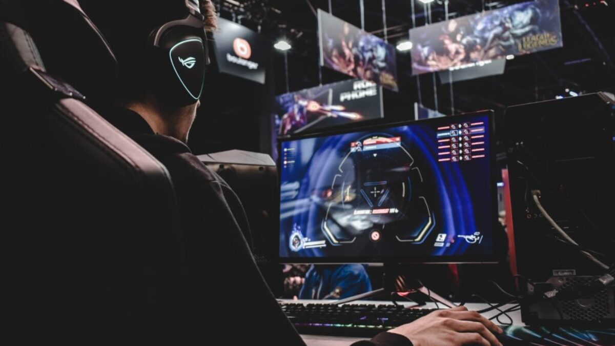 person sitting on gaming chair while playing video game