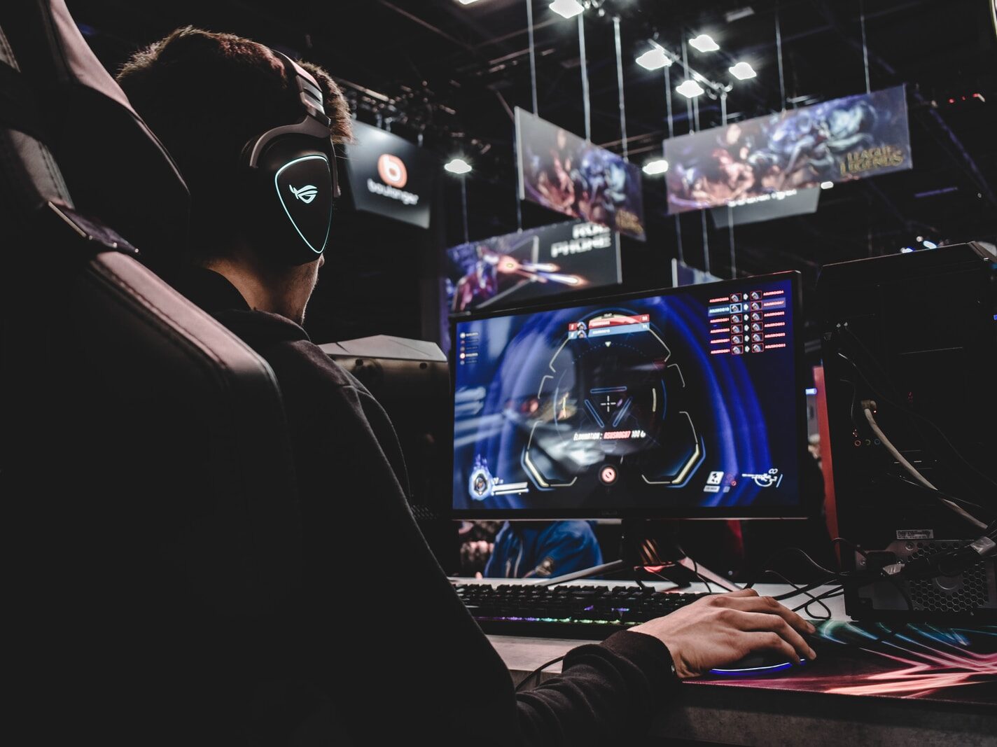 person sitting on gaming chair while playing video game