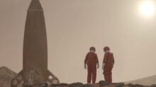 3 men standing on rocky shore during daytime