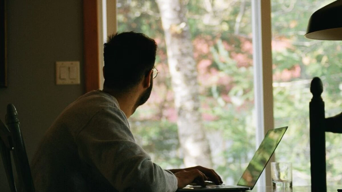 man in gray hoodie using laptop computer