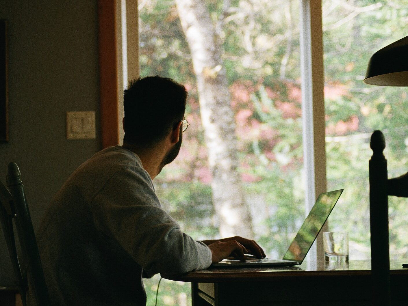 man in gray hoodie using laptop computer
