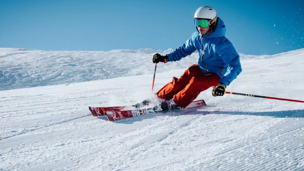 man ice skiing on hill