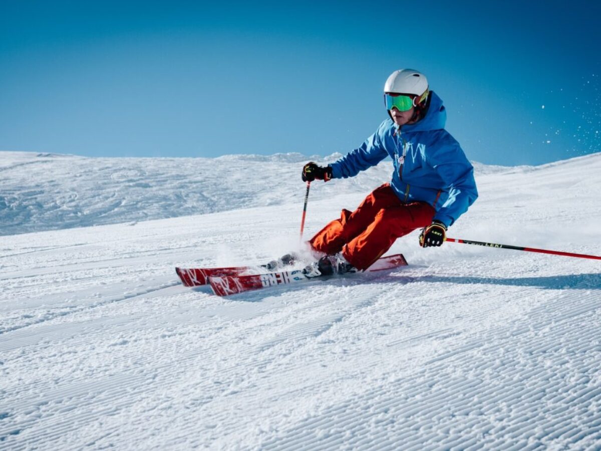 man ice skiing on hill