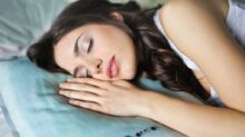 woman sleeping on blue throw pillow