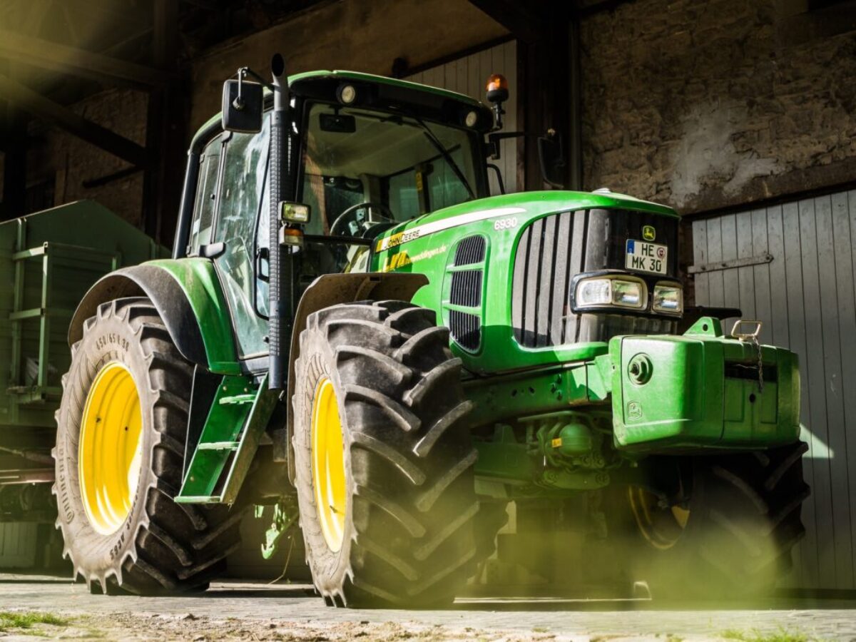 green and yellow tractor in garage