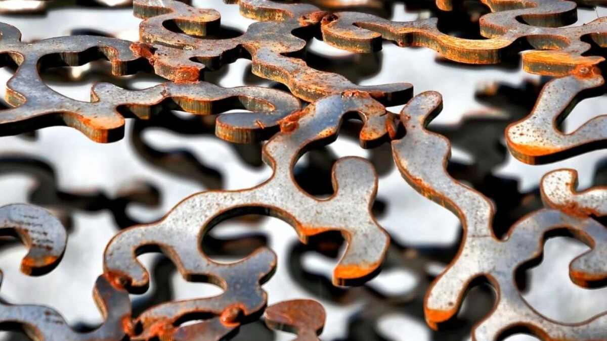 shallow focus photography of gray cut-out metal frame