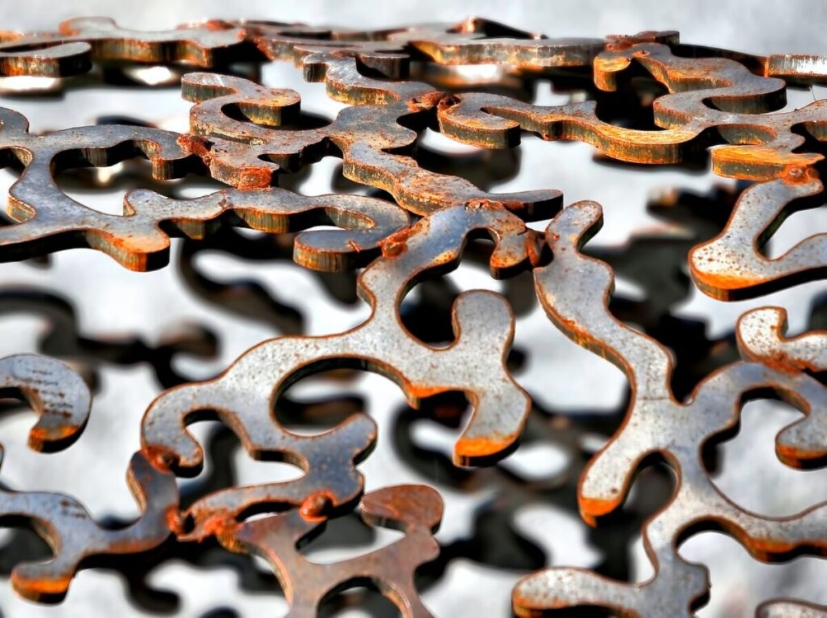 shallow focus photography of gray cut-out metal frame