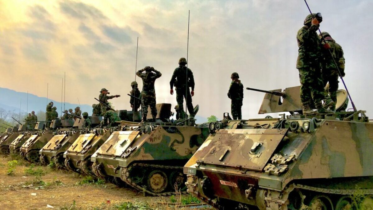 soldiers on top of battle tanks