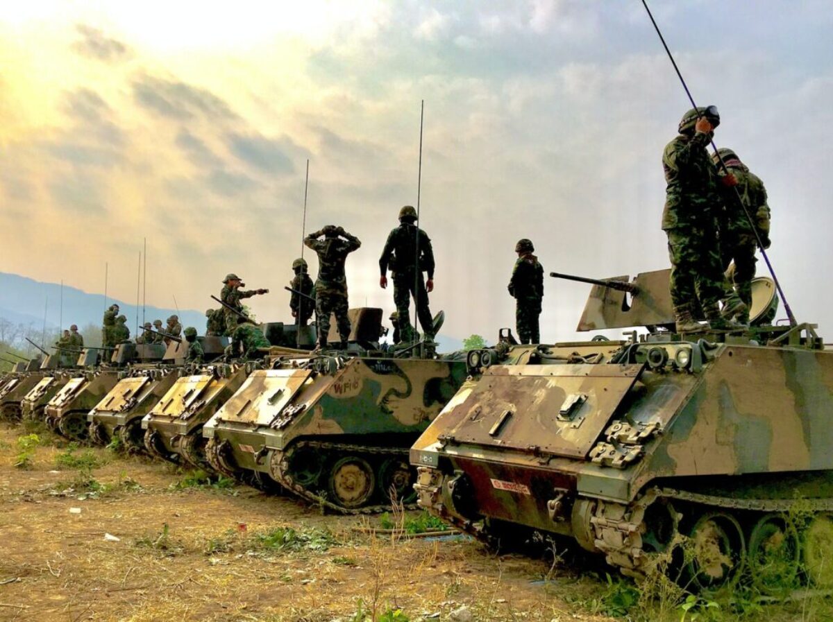 soldiers on top of battle tanks