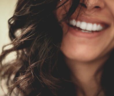 long black haired woman smiling close-up photography