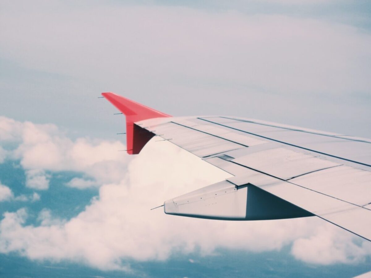 flying airplane surrounded by clouds