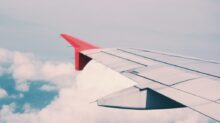 flying airplane surrounded by clouds