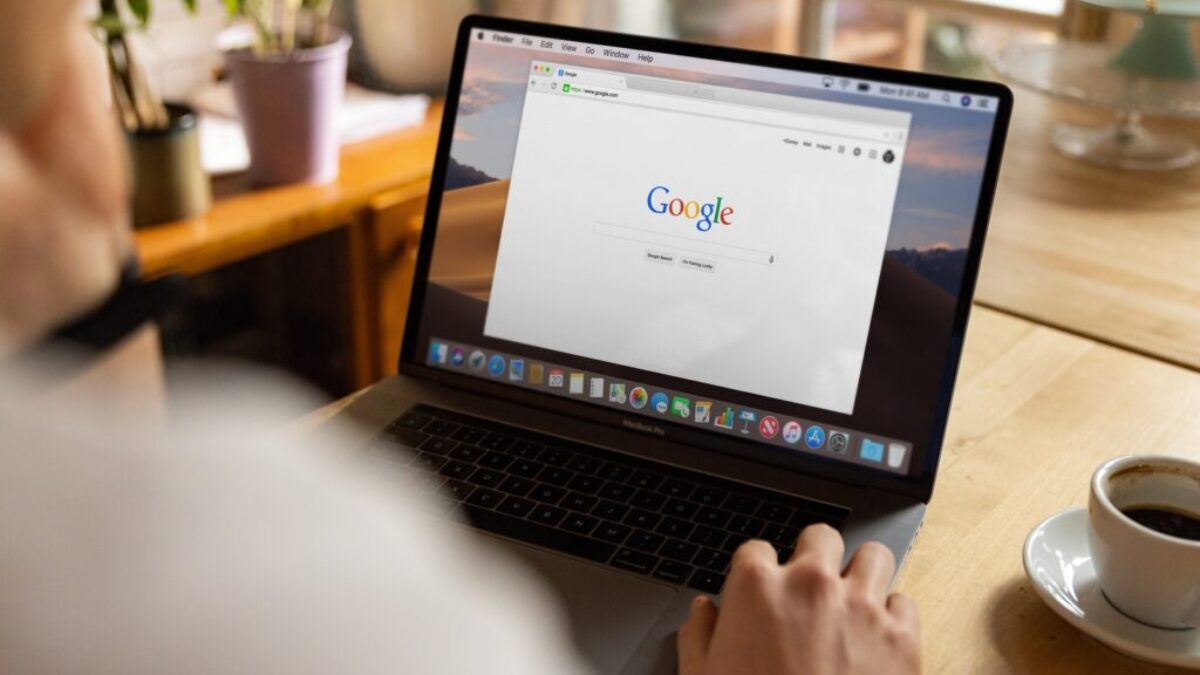 person using macbook pro on table