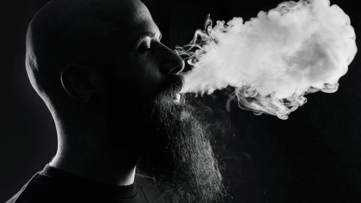 man smoking with black background