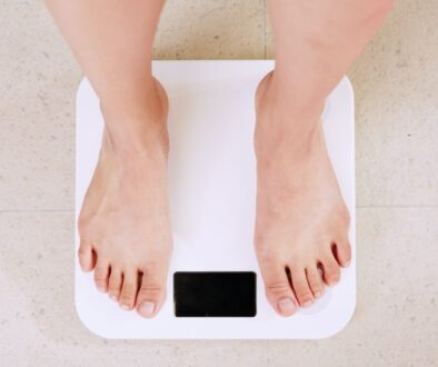 person standing on white digital bathroom scale