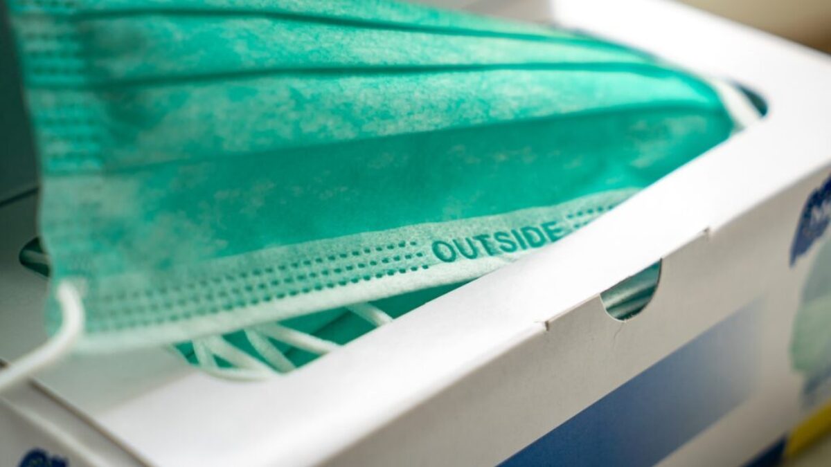 teal plastic tray on white and blue plastic container