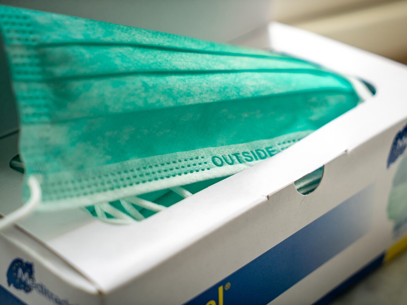 teal plastic tray on white and blue plastic container