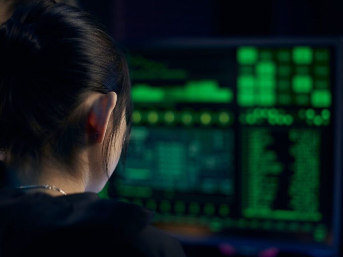 Woman in Black Shirt Looking at Neon Lights