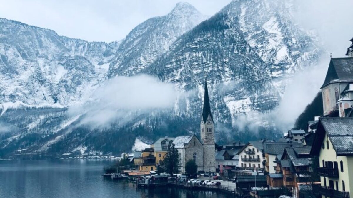 houses near body of water and mountain