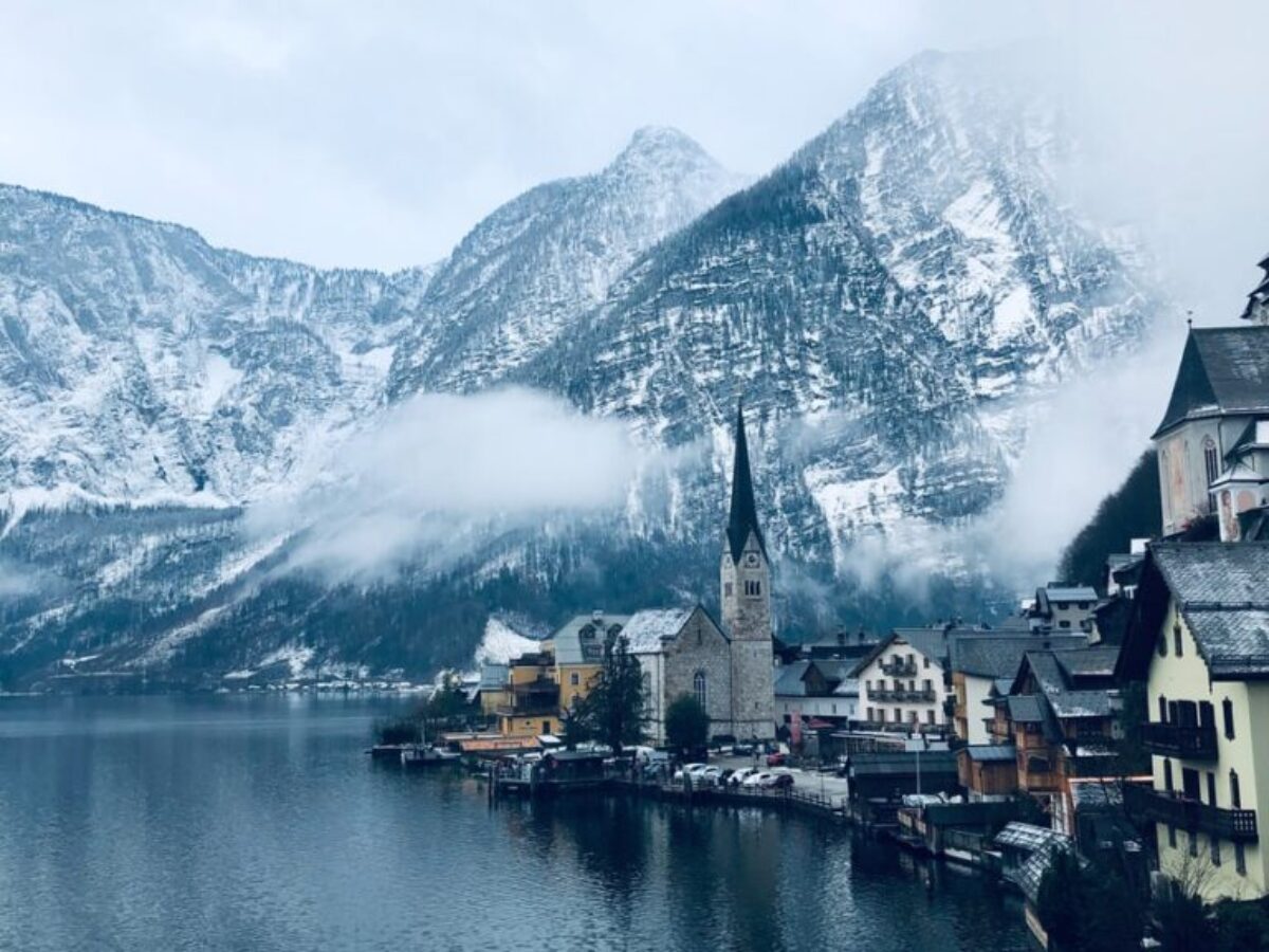 houses near body of water and mountain