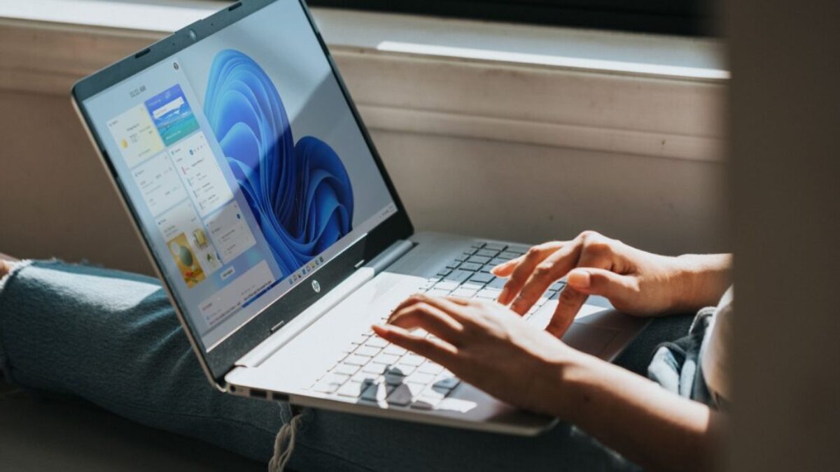 person using Windows 11 computer on lap