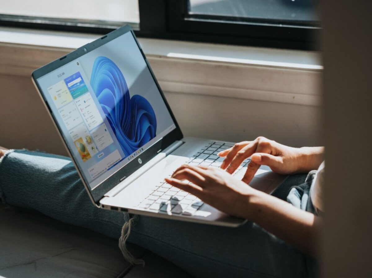 person using Windows 11 computer on lap
