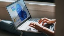 person using Windows 11 computer on lap